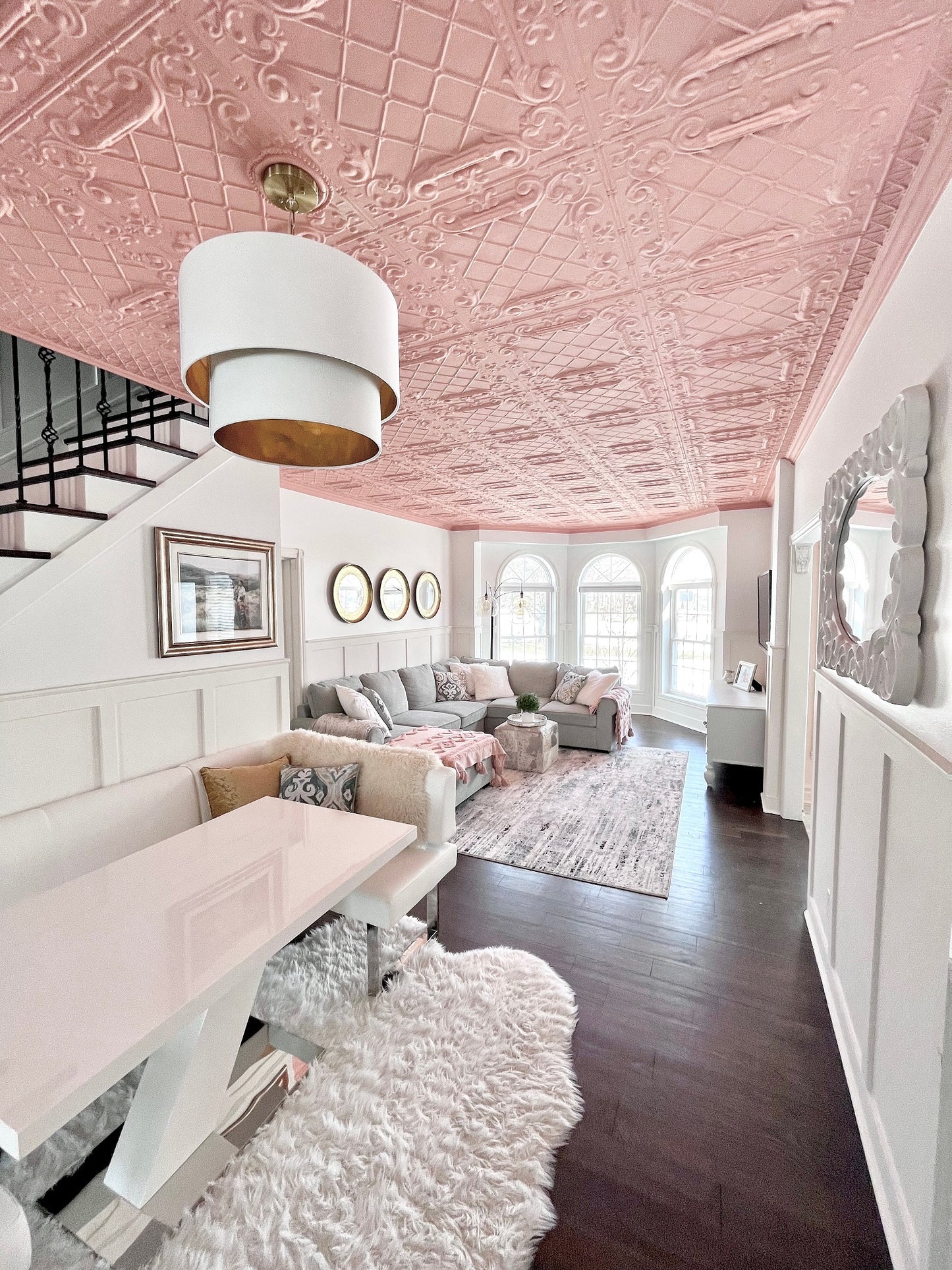dining room with white and gold chandelier, pink room with white chandelier