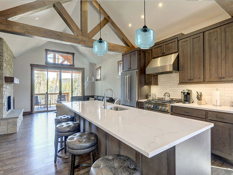 kitchen with large island and blue pendant lights