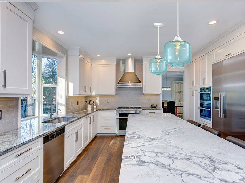 Kitchen with big island and blue glass pendant light