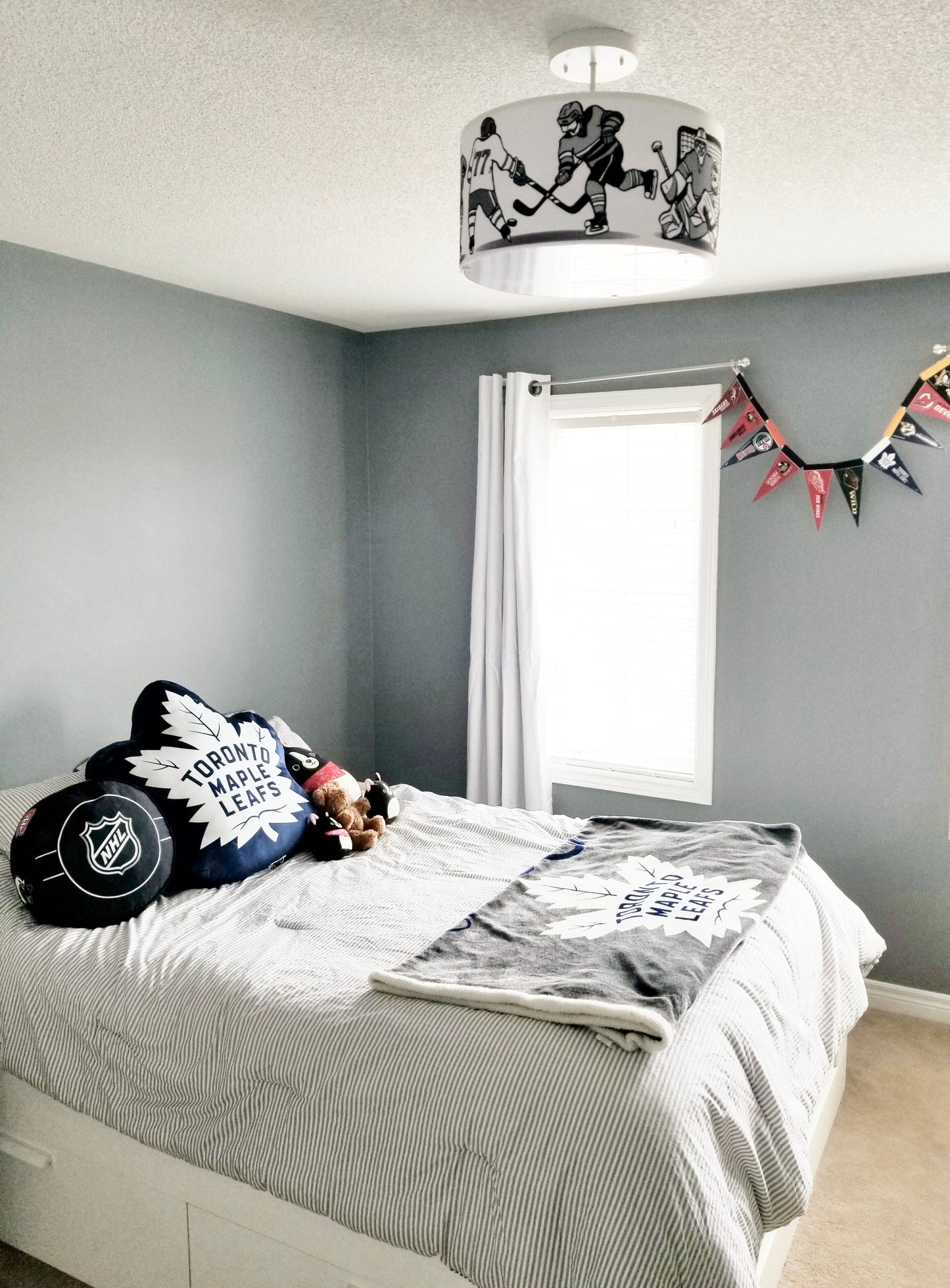 kids bedroom with hockey light fixture