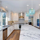Kitchen with big island and blue glass pendant light