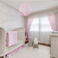 pink round chandelier in nursery, pink globe chandelier in baby's room