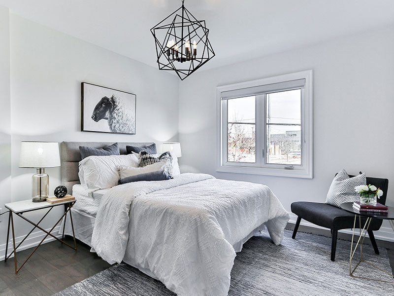 Modern bedroom with black chandelier, geometric chandelier, trending lighting in bedroom